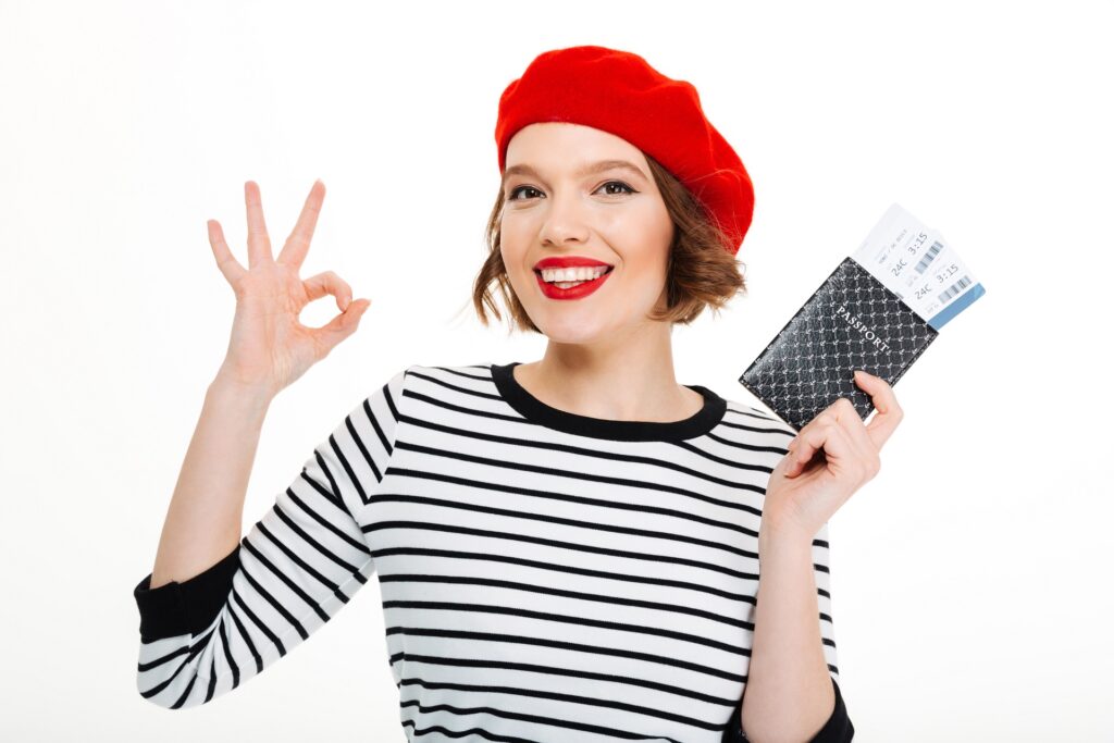 Young happy tourist lady holding passport with tickets
